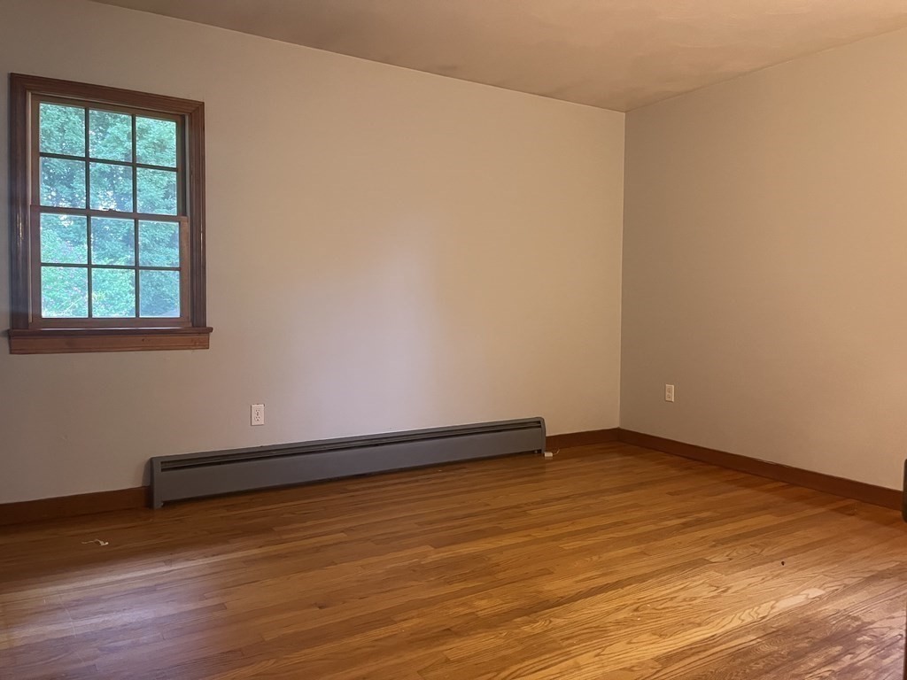 631 Allen Street Springfield, MA 01118 - Photo 6 of 15 an empty room with wooden floor and windows