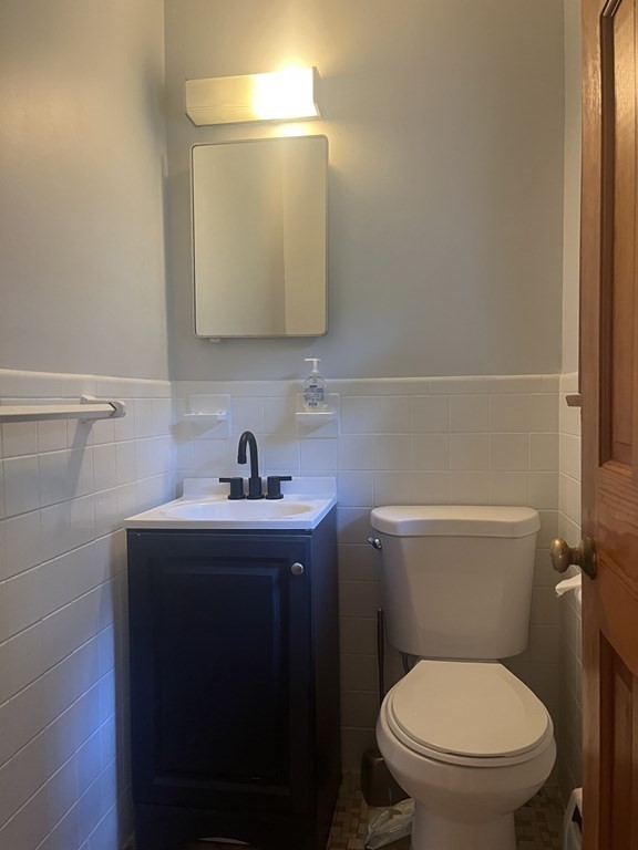 631 Allen Street Springfield, MA 01118 - Photo 8 of 15 a bathroom with a toilet a sink and mirror