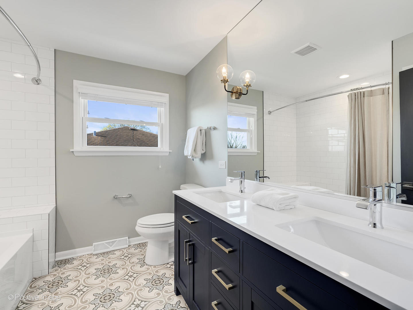 452 East Adams Street Elmhurst, IL 60126 - Photo 16 of 27 a bathroom with a double vanity sink toilet and a mirror