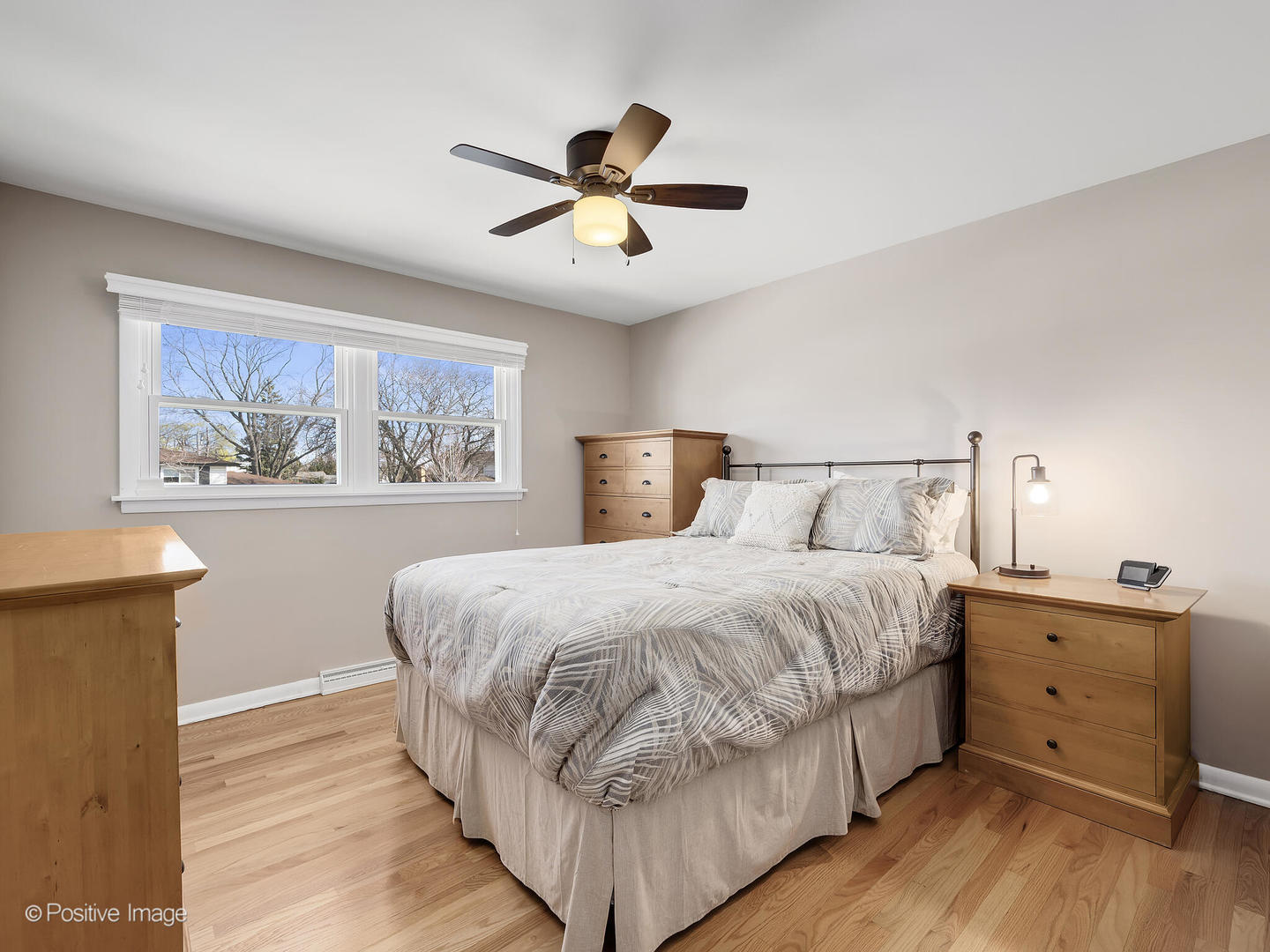 452 East Adams Street Elmhurst, IL 60126 - Photo 17 of 27 a bedroom with a large bed and a chandelier