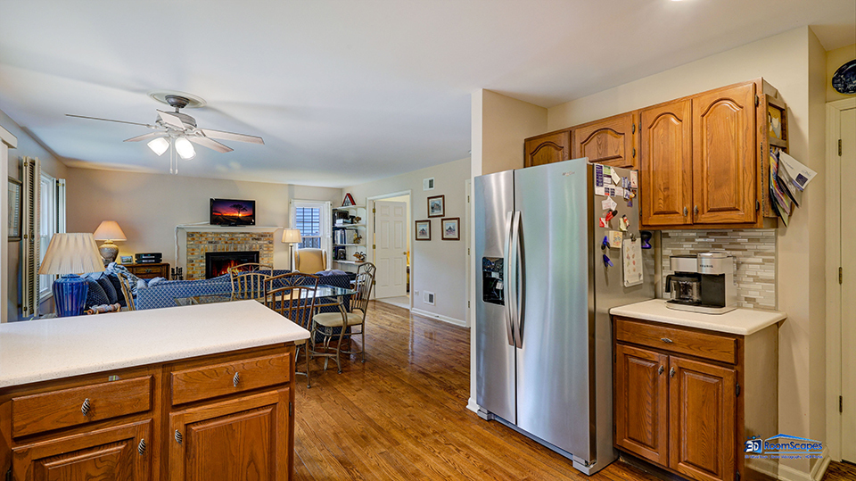 245 Pilgrims Path Gurnee, IL 60031 - Photo 12 of 54 a kitchen with a refrigerator a stove and a dining table with wooden floor