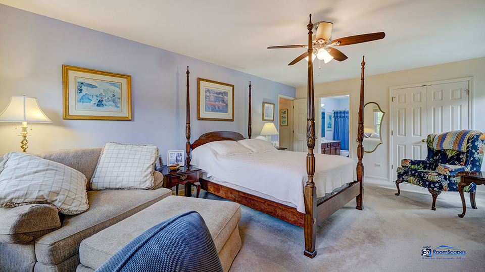 245 Pilgrims Path Gurnee, IL 60031 - Photo 21 of 54 a bedroom with a bed and a chandelier