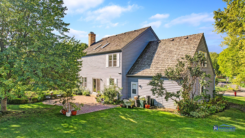 245 Pilgrims Path Gurnee, IL 60031 - Photo 37 of 54 a front view of a house with a garden and plants