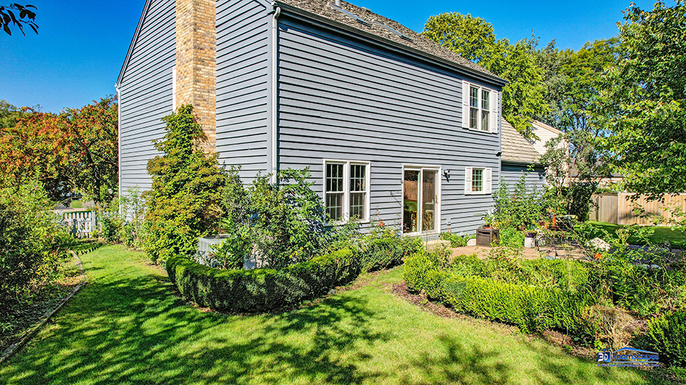 245 Pilgrims Path Gurnee, IL 60031 - Photo 41 of 54 a yellow house with flower garden