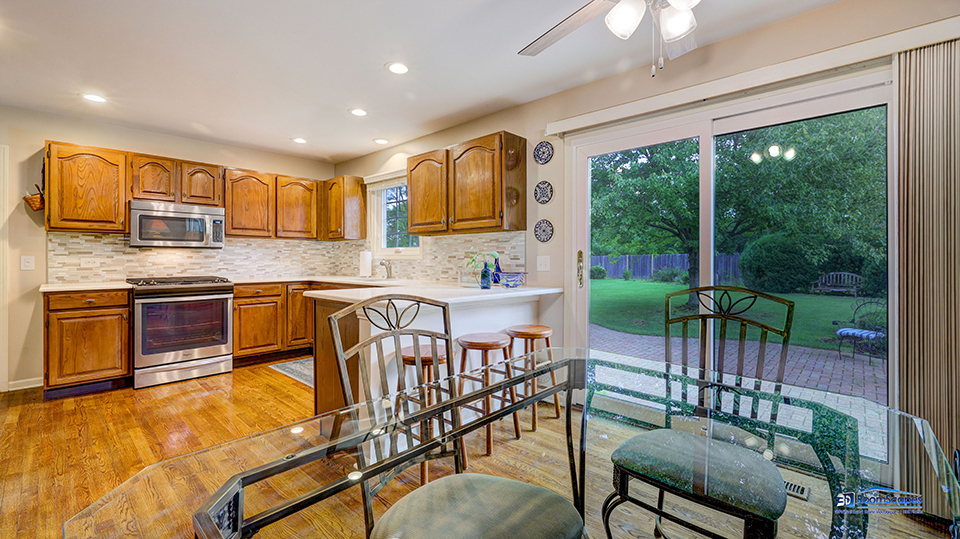 245 Pilgrims Path Gurnee, IL 60031 - Photo 9 of 54 a kitchen with stainless steel appliances granite countertop a stove top oven a sink dishwasher a dining table and chairs with wooden floor