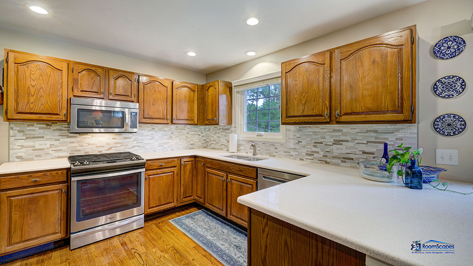 245 Pilgrims Path Gurnee, IL 60031 - Photo 10 of 54 a kitchen with stainless steel appliances granite countertop a sink stove and microwave