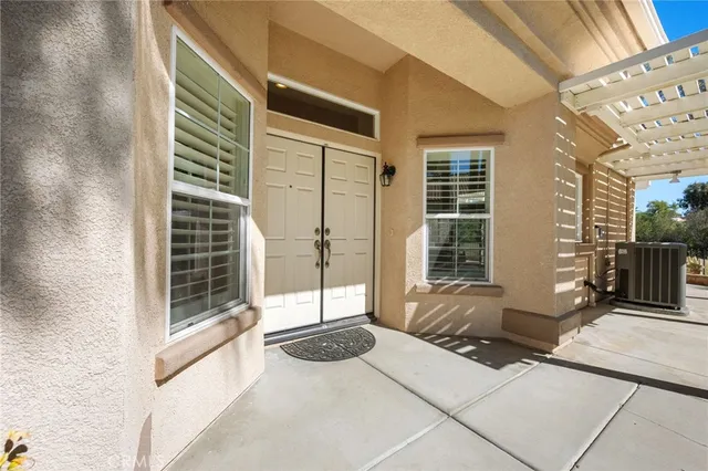 a view of a bedroom with a balcony and floor to ceiling window