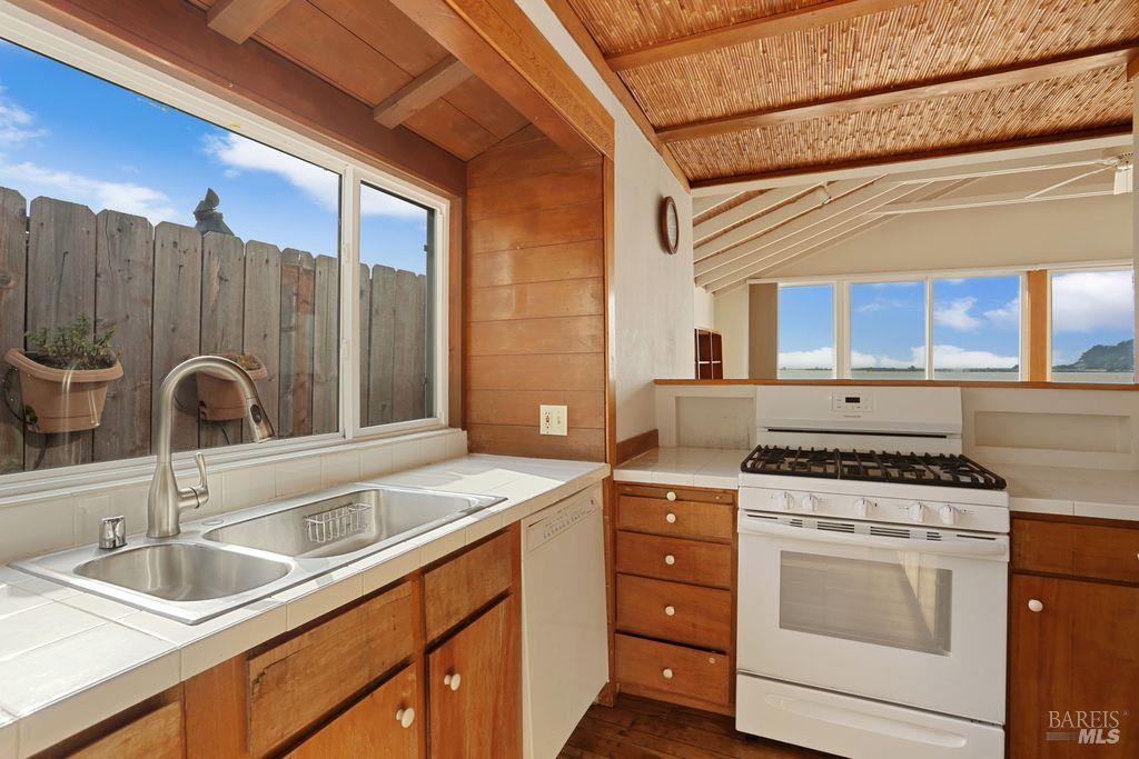 34 Sandy Beach Road Vallejo, CA 94590 - Photo 27 of 63 a kitchen with granite countertop a sink stainless steel appliances and cabinets