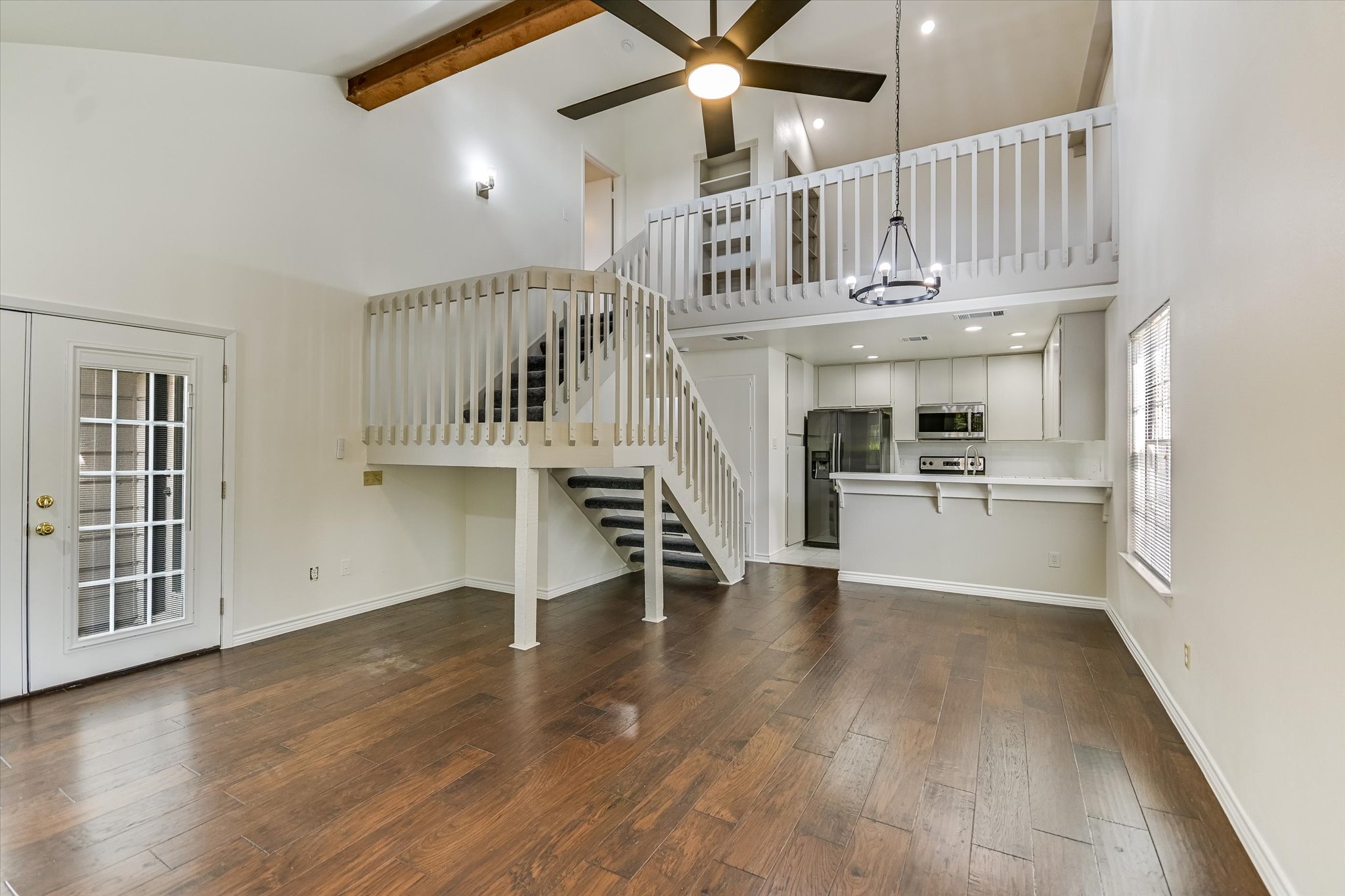 1748 Ohlen Road, Unit 37 Austin, TX 78757 - Photo 5 of 16 Gleaming hardwood floors and a vaulted, beamed ceiling highlight this open multi-level living area.