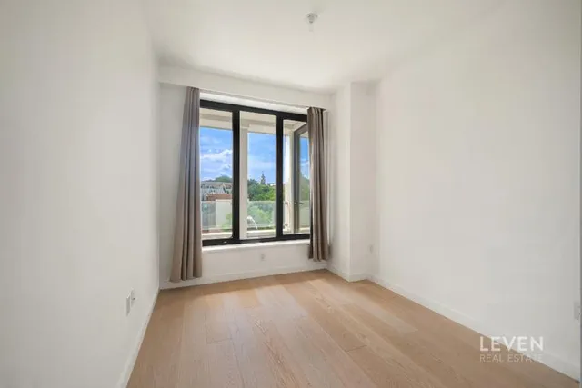 a bedroom with a large bed and a large window