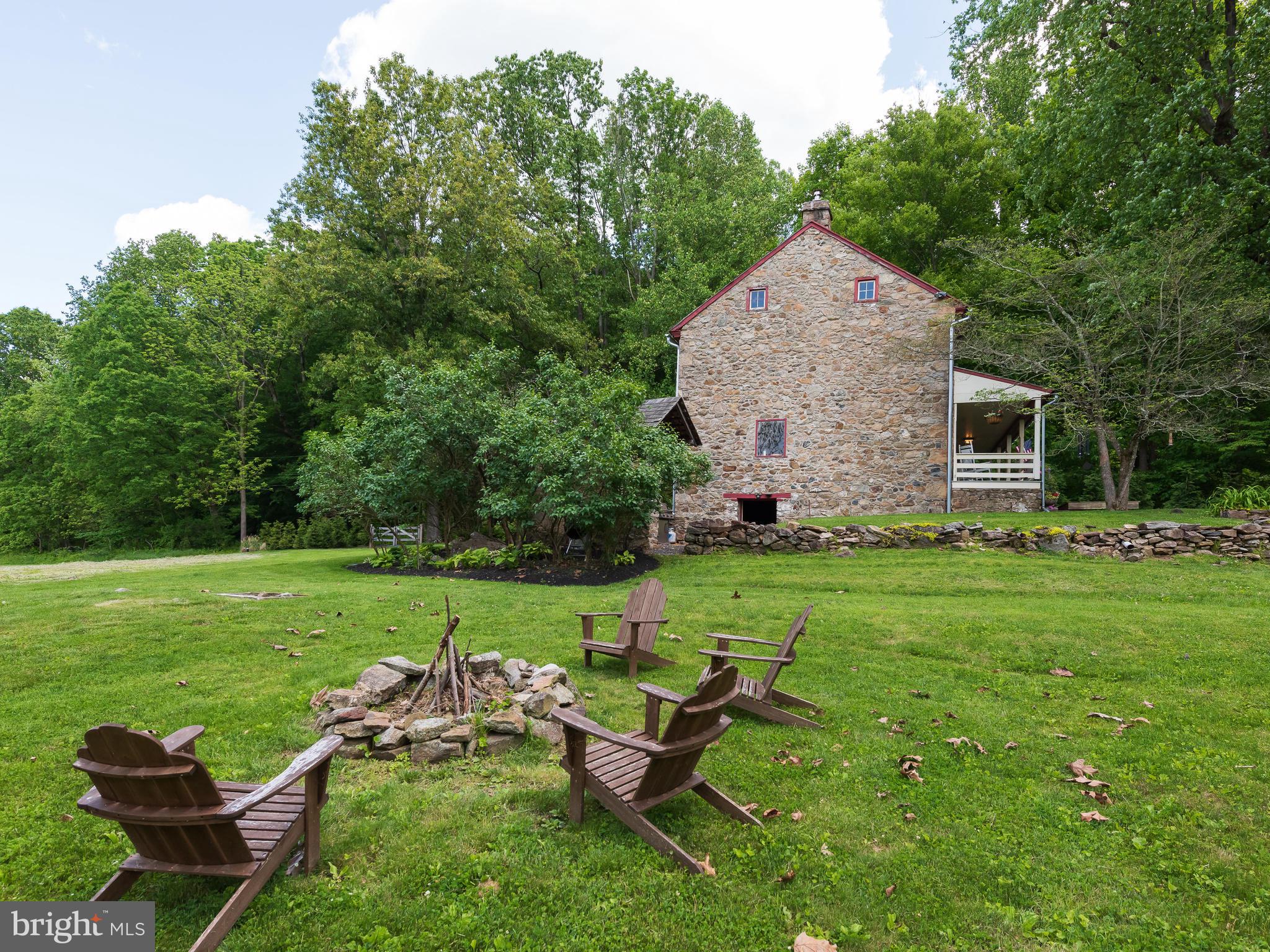 187 Iron Bridge Road Glenmoore, PA 19343 - Photo 9 of 58 Side of stone home & firepit