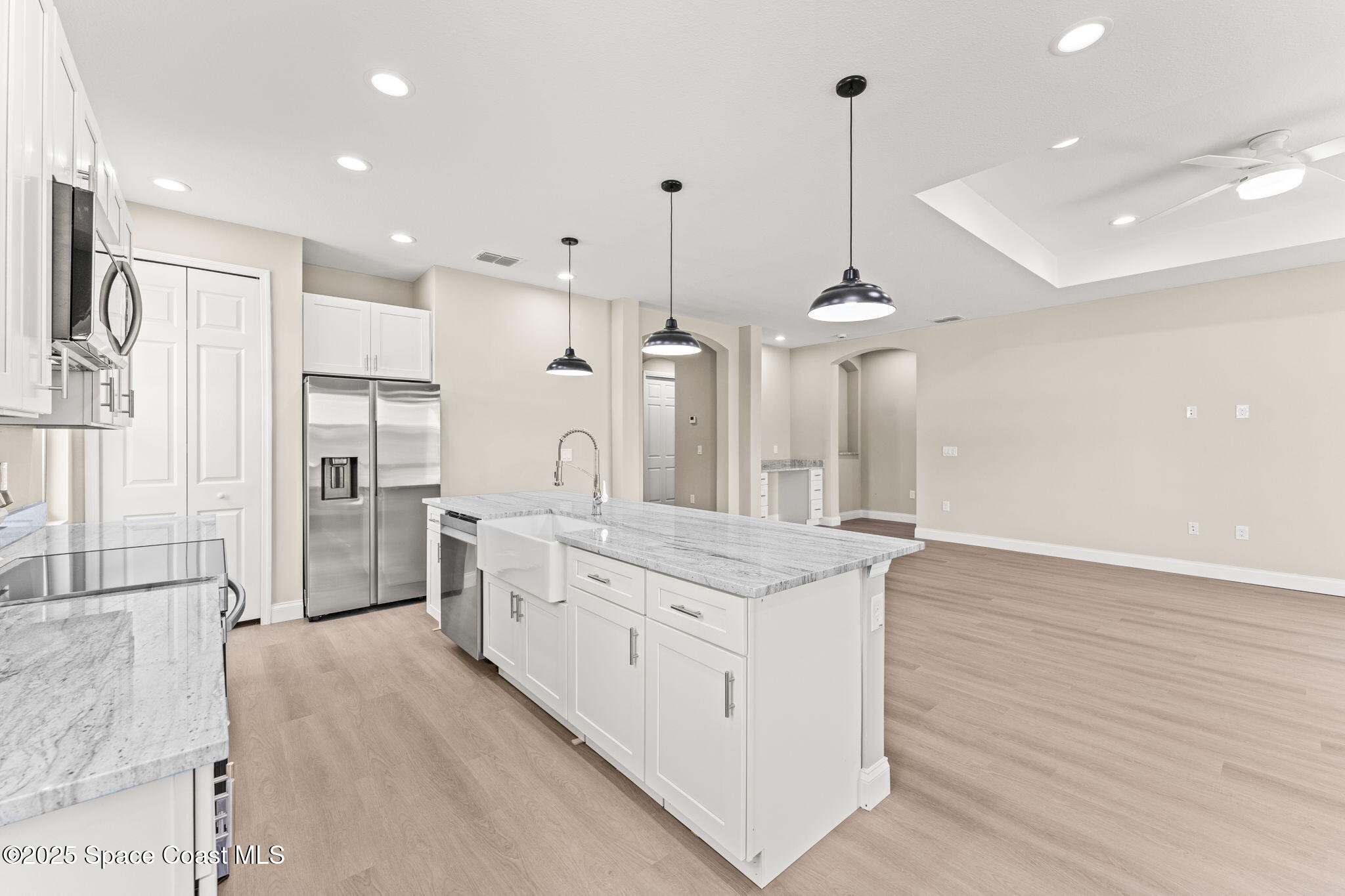 241 Sarah Road Southwest Palm Bay, FL 32908 - Photo 17 of 54 a large kitchen with stainless steel appliances kitchen island a large counter top and a chandelier
