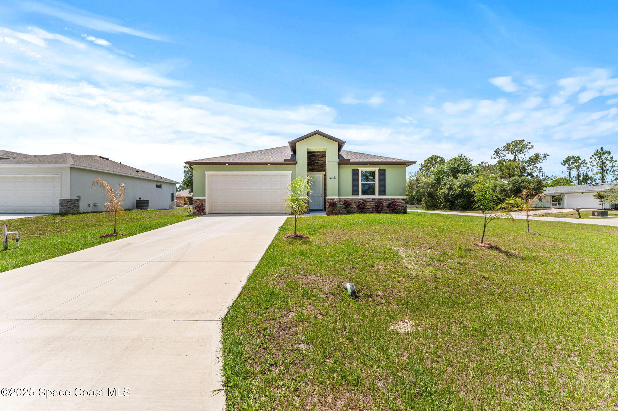 241 Sarah Road Southwest Palm Bay, FL 32908 - Photo 2 of 54 a front view of a house with a yard