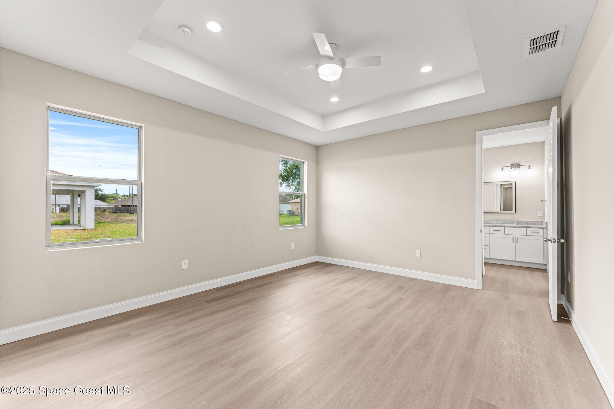 241 Sarah Road Southwest Palm Bay, FL 32908 - Photo 23 of 54 wooden floor in an empty room with a window