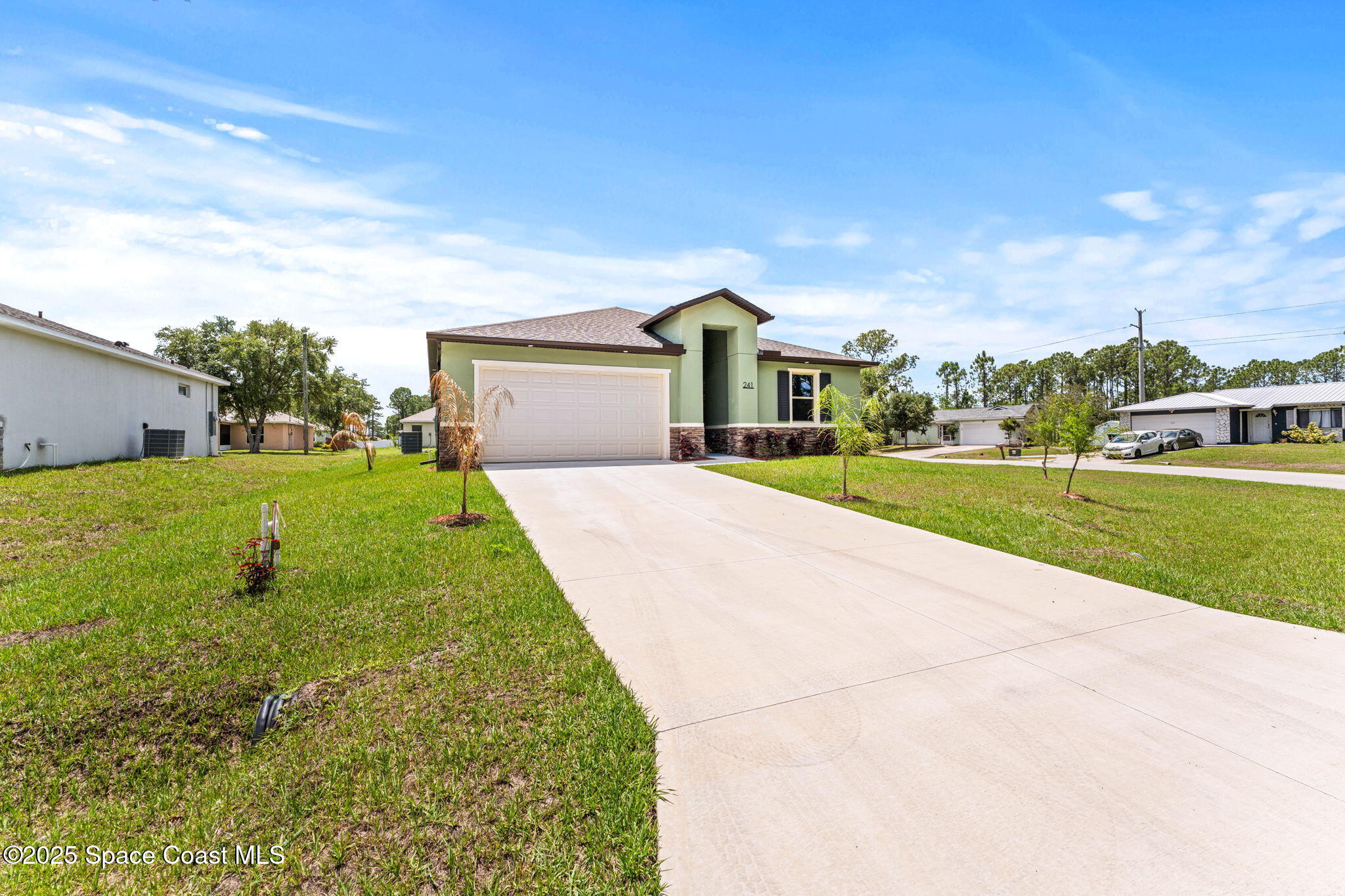 241 Sarah Road Southwest Palm Bay, FL 32908 - Photo 3 of 54 a front view of a house with a yard