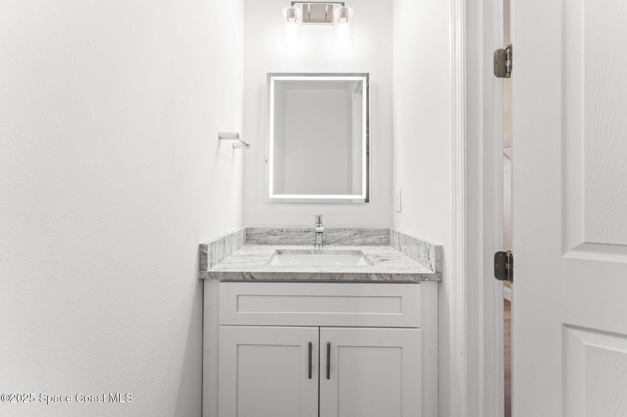 241 Sarah Road Southwest Palm Bay, FL 32908 - Photo 32 of 54 a bathroom with a granite countertop sink and a mirror