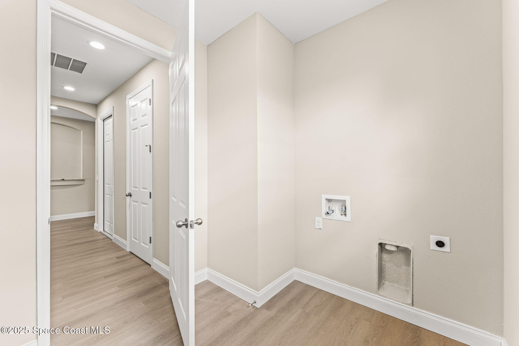 241 Sarah Road Southwest Palm Bay, FL 32908 - Photo 34 of 54 a view of a hallway with wooden floor and closet