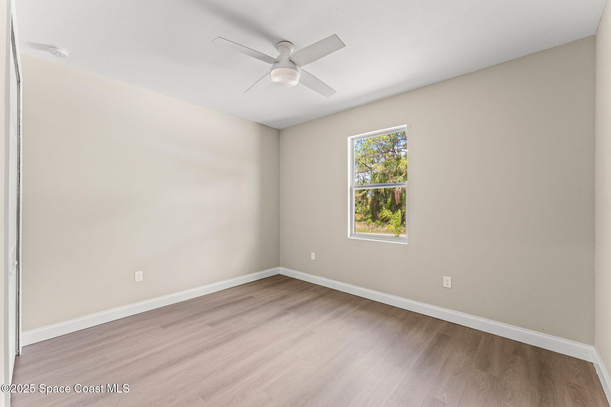 241 Sarah Road Southwest Palm Bay, FL 32908 - Photo 38 of 54 an empty room with window and ceiling fan