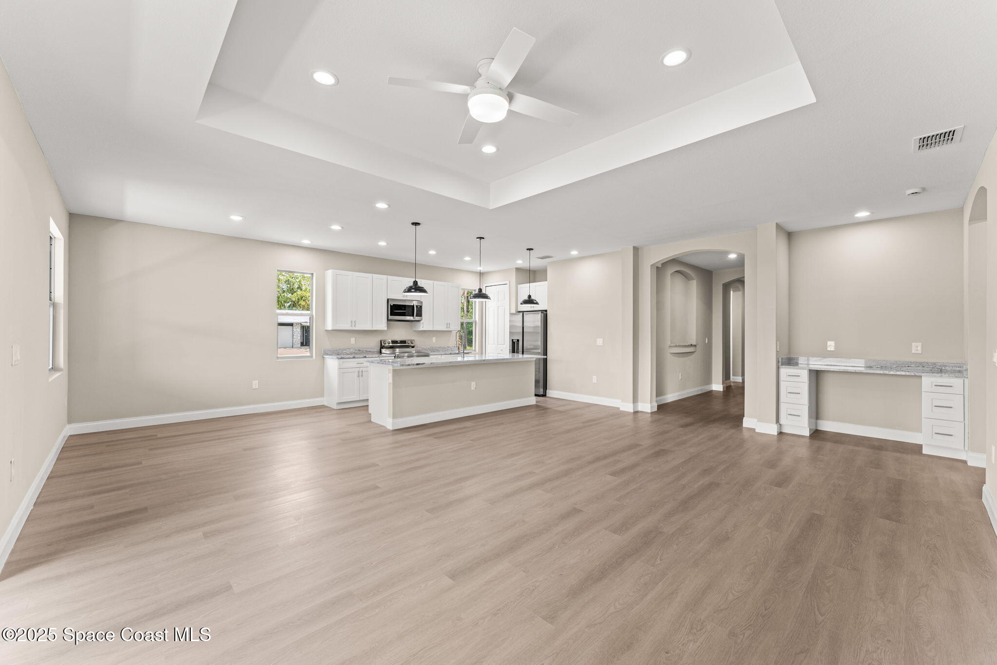 241 Sarah Road Southwest Palm Bay, FL 32908 - Photo 8 of 54 a view of kitchen with wooden floor and windows