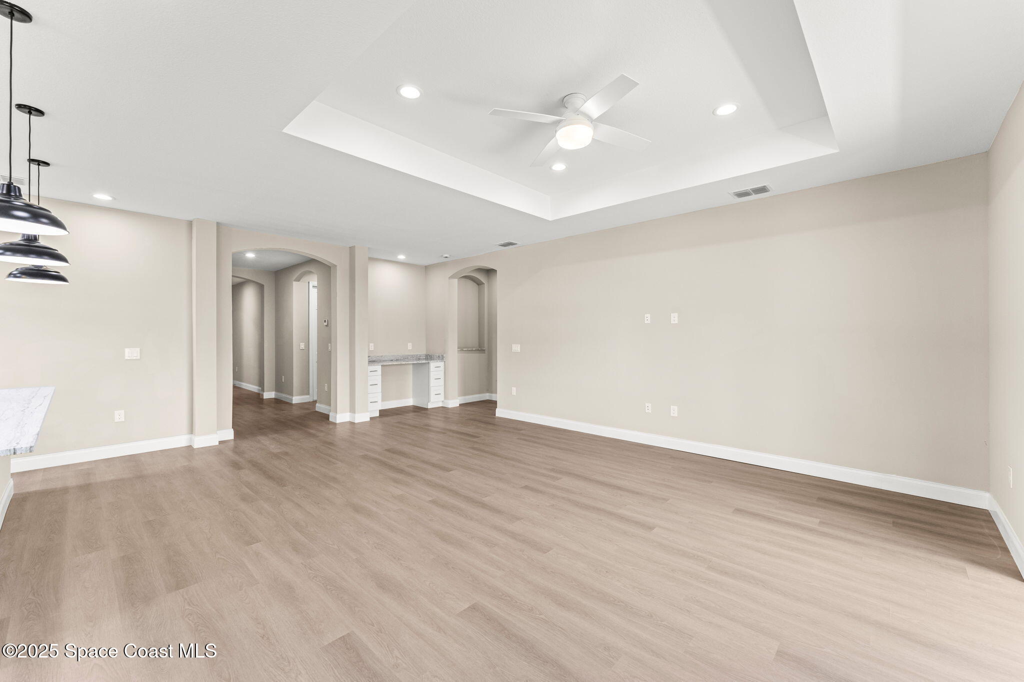 241 Sarah Road Southwest Palm Bay, FL 32908 - Photo 10 of 54 wooden floor in an empty room with a window