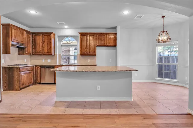 a view of wooden floor and windows in a room