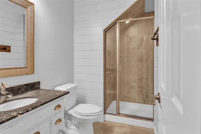 a bedroom with a balcony a bed and a chandelier