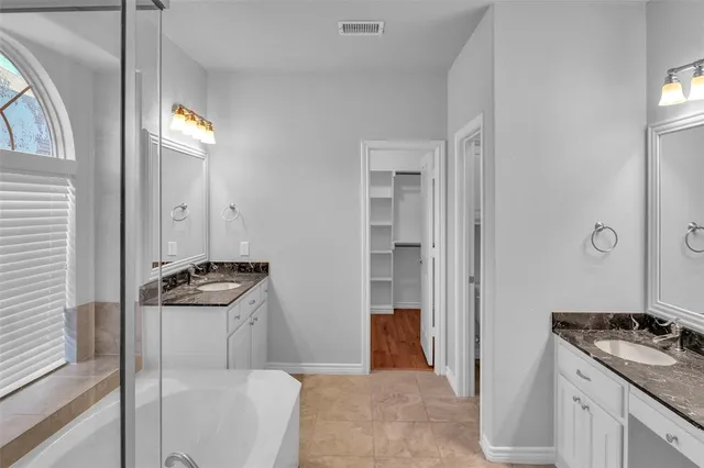 a bathroom with a granite countertop shower mirror and a sink