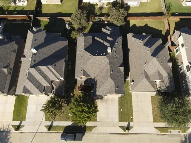 an aerial view of residential houses with outdoor space
