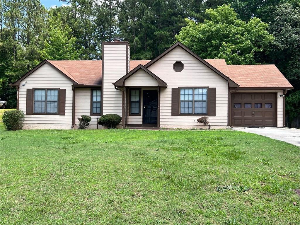 10390 Candlelight Road Jonesboro, GA 30238 - Photo 1 of 1 a front view of house with yard and green space