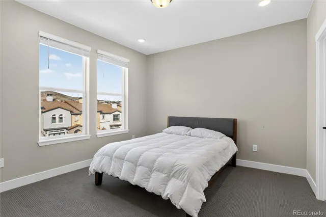 a bed sitting in a bedroom next to a window