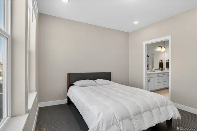 a bedroom with a bed and a view of bathroom