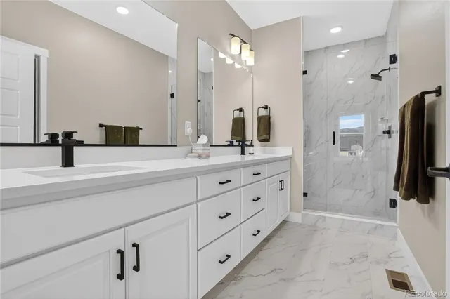 a bathroom with a double sink mirror and shower