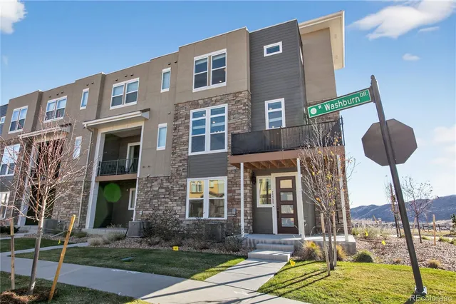 a view of a brick building next to a yard