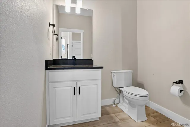 a bathroom with a sink toilet and mirror