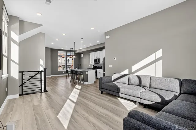 a living room with furniture and wooden floor