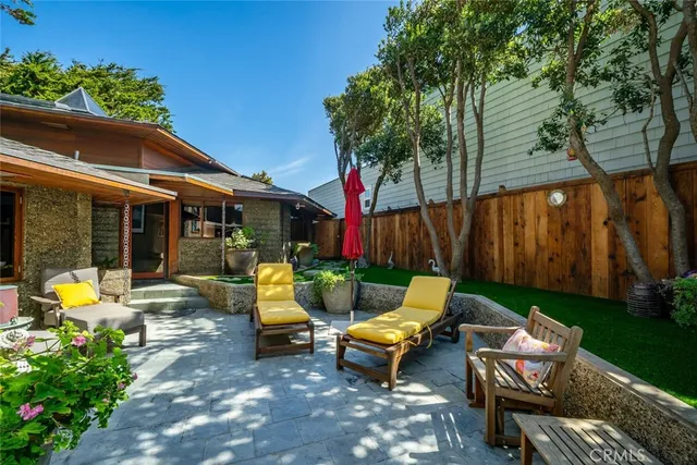 a view of a house with backyard and sitting area