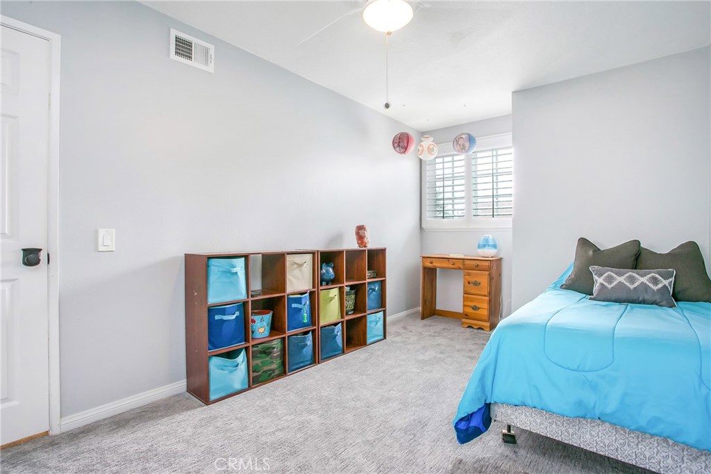 22876 Broadleaf Lake Forest, CA 92630 - Photo 16 of 26 a bedroom with a bed and a book shelf