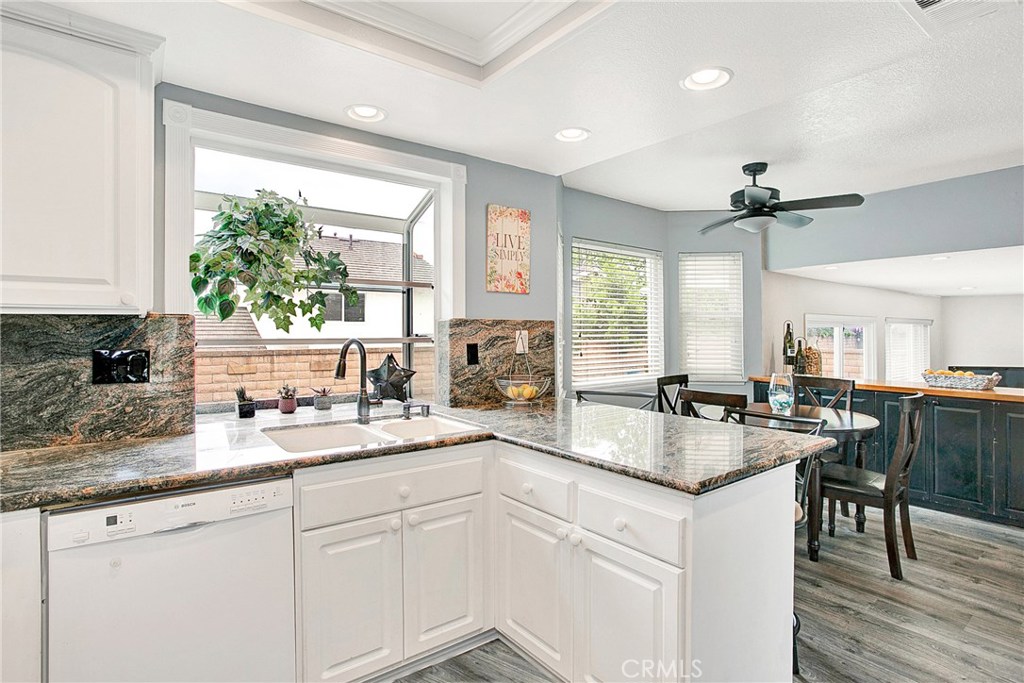 22876 Broadleaf Lake Forest, CA 92630 - Photo 7 of 26 a open kitchen with granite countertop a sink a center island and cabinets
