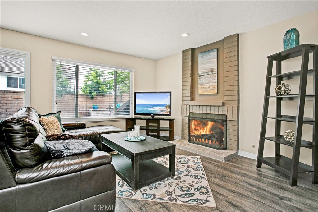 22876 Broadleaf Lake Forest, CA 92630 - Photo 10 of 26 a living room with furniture and a fireplace