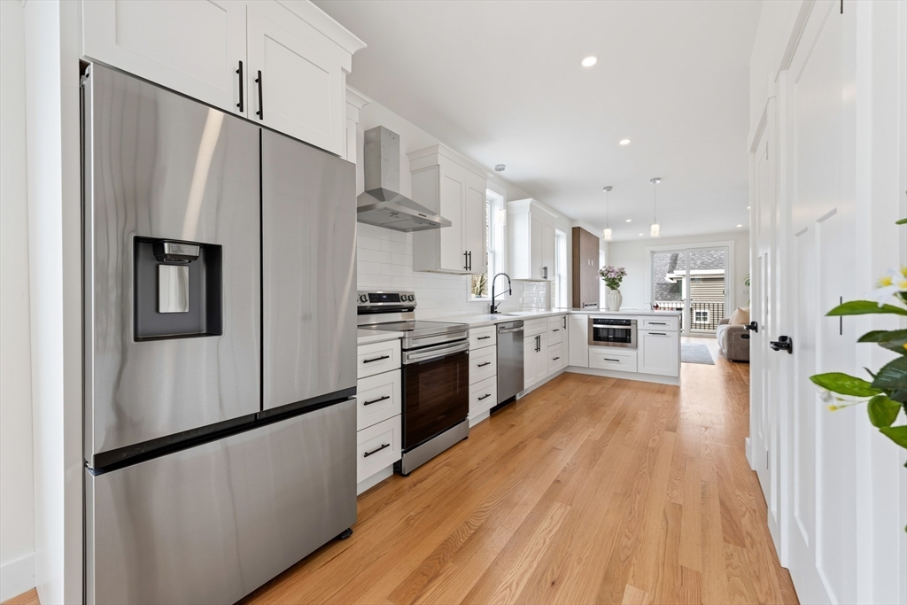 2 Old County Road, Unit 14 Salisbury, MA 01952 - Photo 4 of 33 a kitchen with stainless steel appliances a refrigerator and a stove top oven