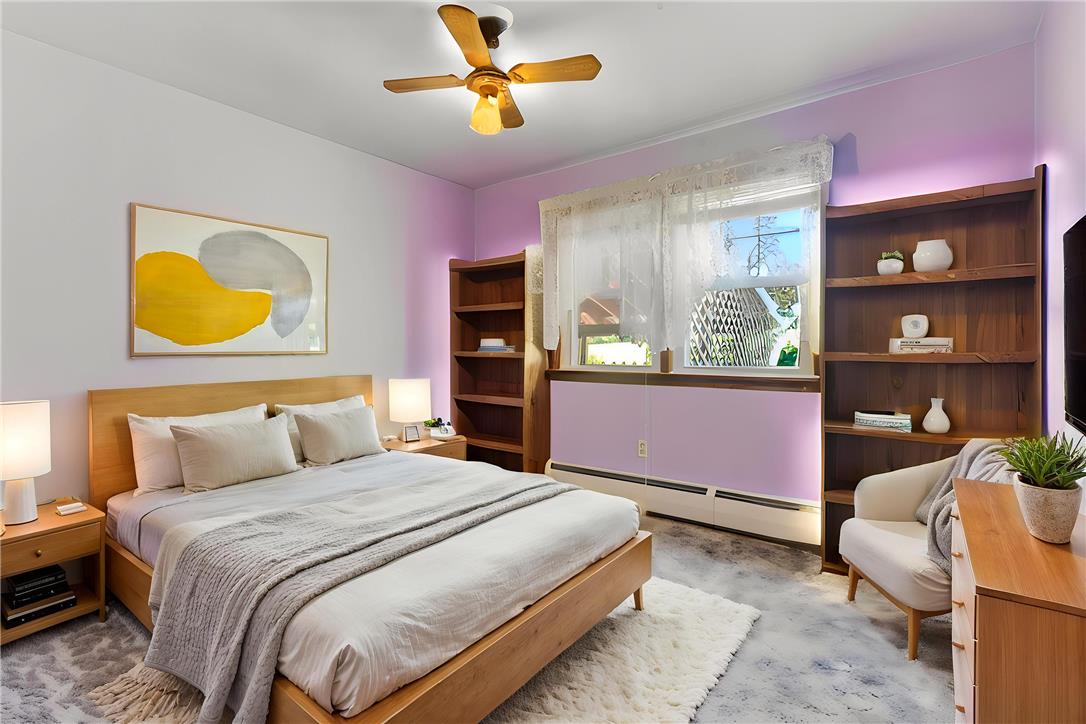 62 Stoney Road Tamaqua, PA 18252 - Photo 35 of 61 Relax in a comfortable bedroom featuring a ceiling fan and convenient shelving for books and decor.