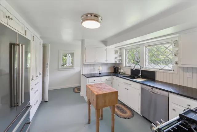 a kitchen with a sink cabinets and window