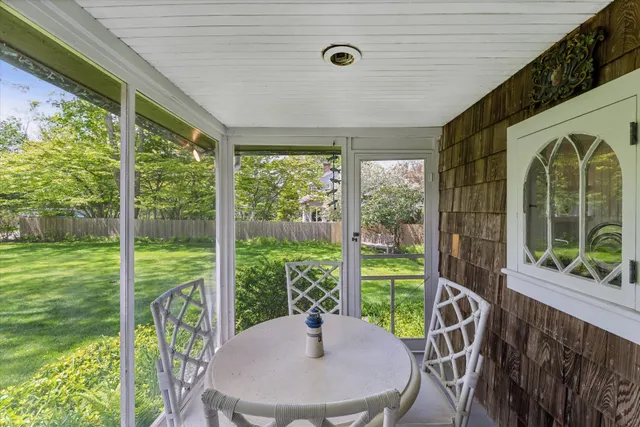a view of a porch with furniture and garden