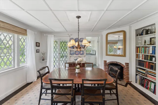 a dining room with furniture a chandelier and window