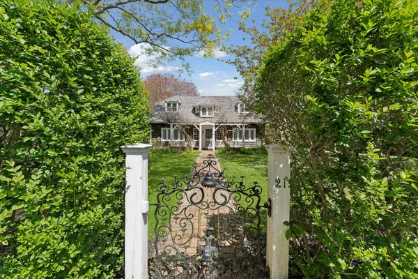 a view of a house with a tree in front of it