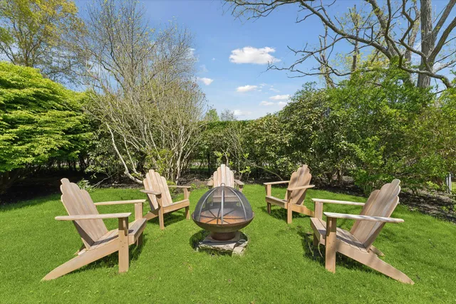a swimming pool with outdoor seating and yard