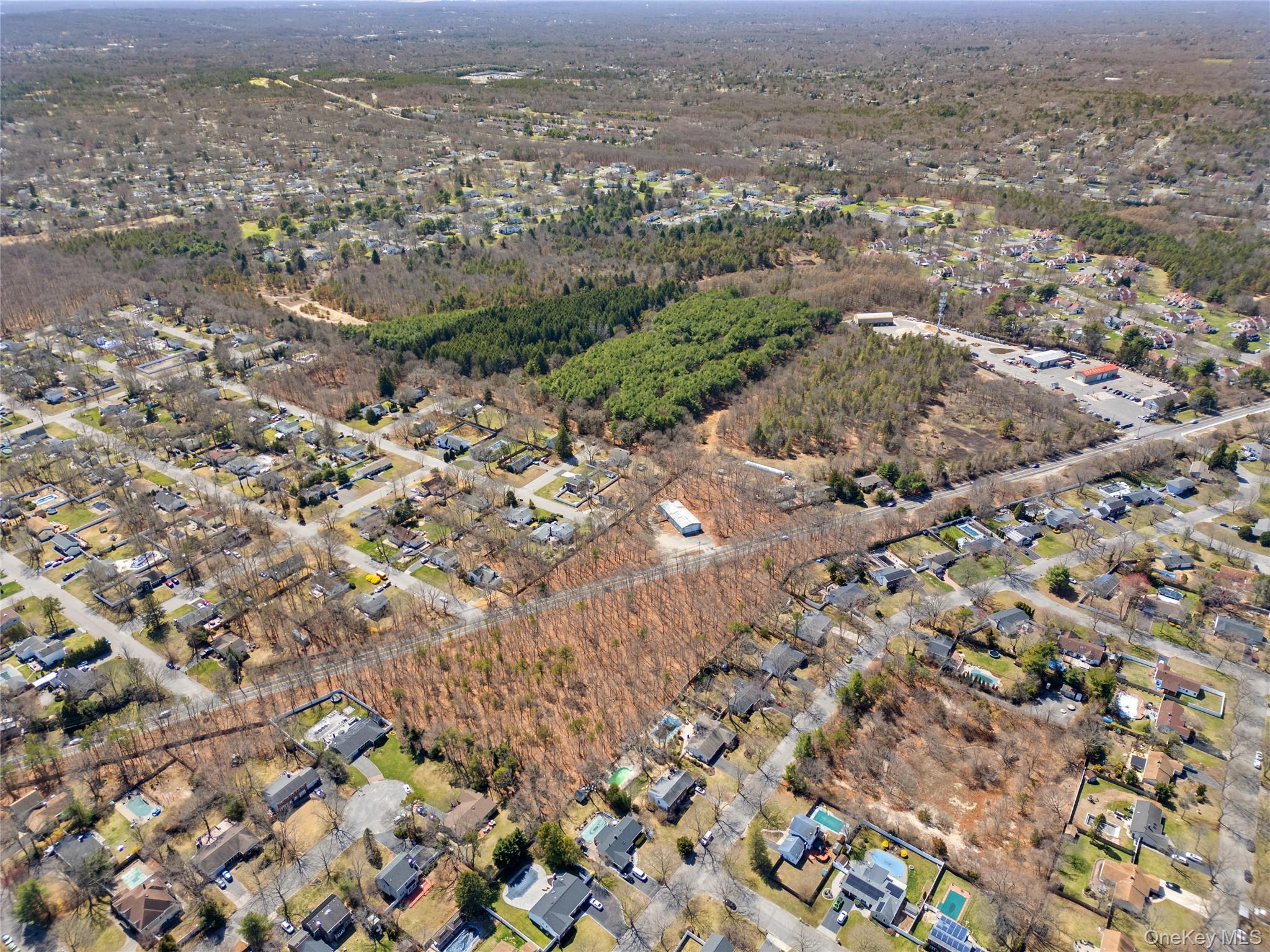 751 Canal Road Mount Sinai, NY 11766 - Photo 3 of 7 an aerial view of residential houses with outdoor space