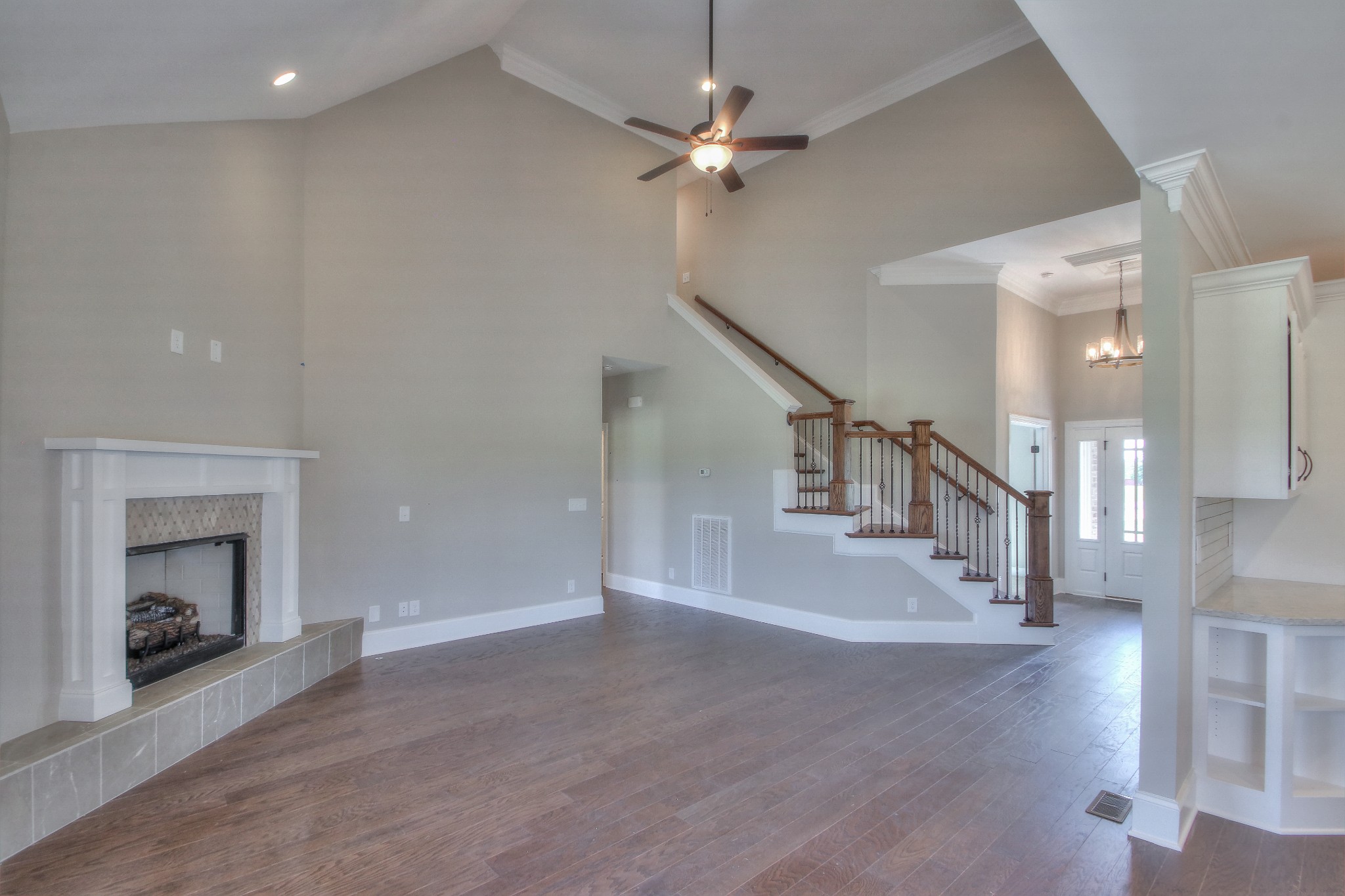 437 Burford Road Lebanon, TN 37087 - Photo 18 of 43 a view of an empty room with a fireplace and a chandelier fan