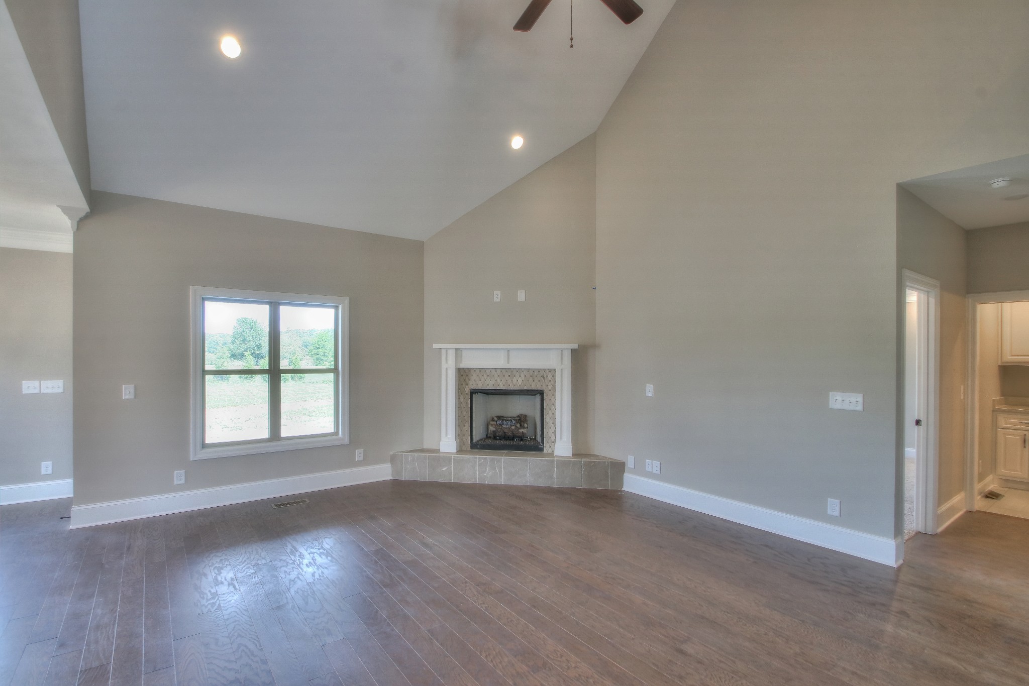 437 Burford Road Lebanon, TN 37087 - Photo 20 of 43 an empty room with wooden floor fireplace and windows