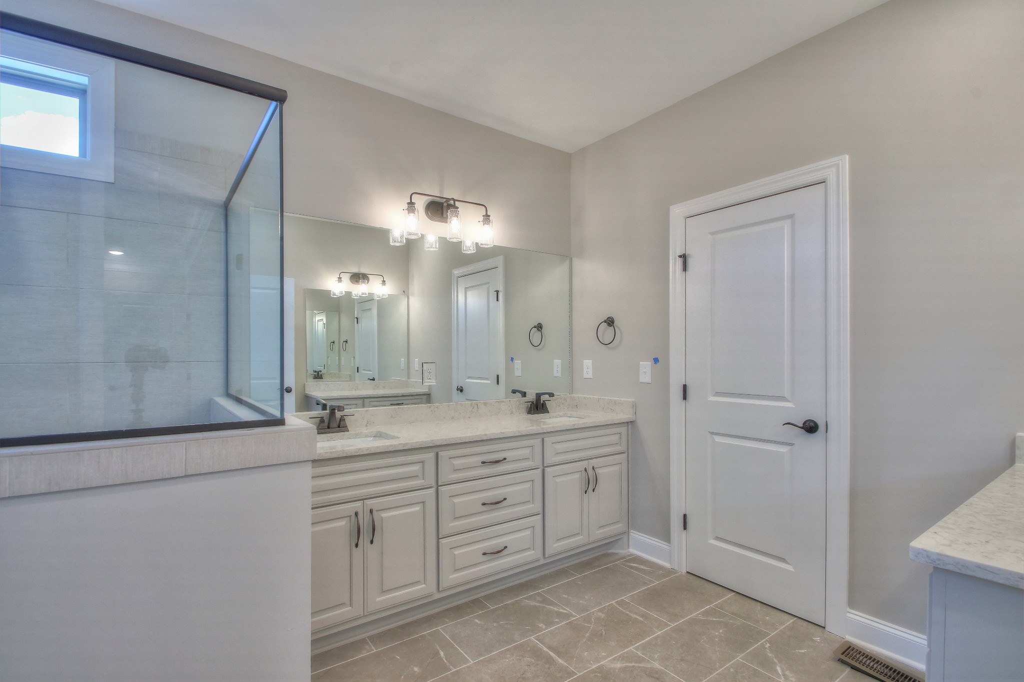 437 Burford Road Lebanon, TN 37087 - Photo 25 of 43 a spacious bathroom with a double vanity sink a large mirror and a shower